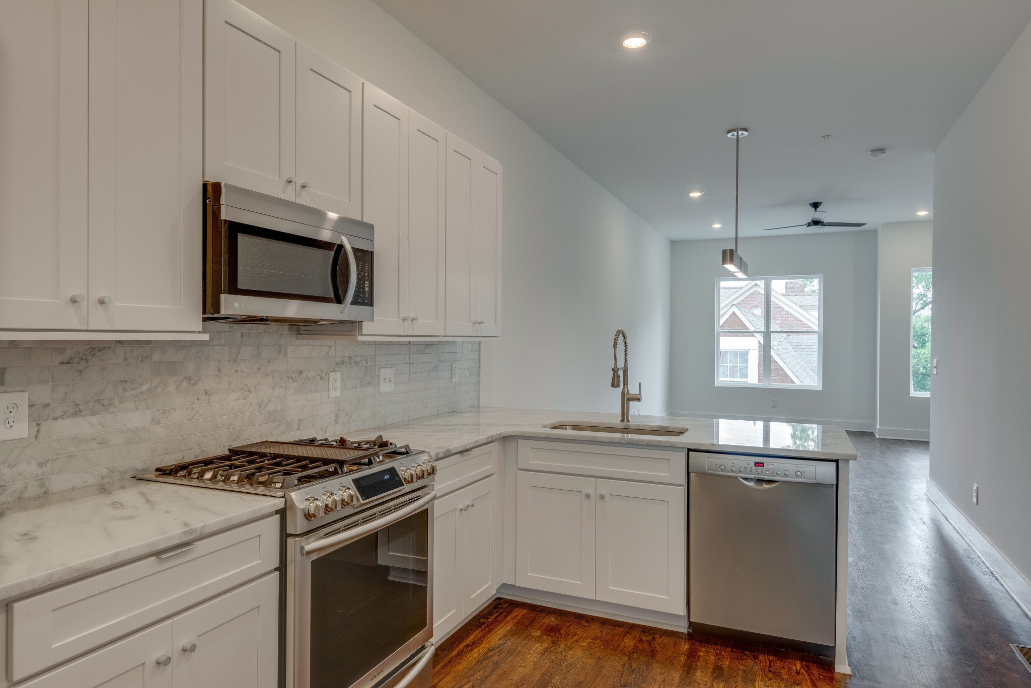 2001 Convent Place, Unit 16 Nashville, TN 37212 - Photo 9 of 24 a kitchen with stainless steel appliances granite countertop white cabinets a sink a stove a window and white wooden cabinets