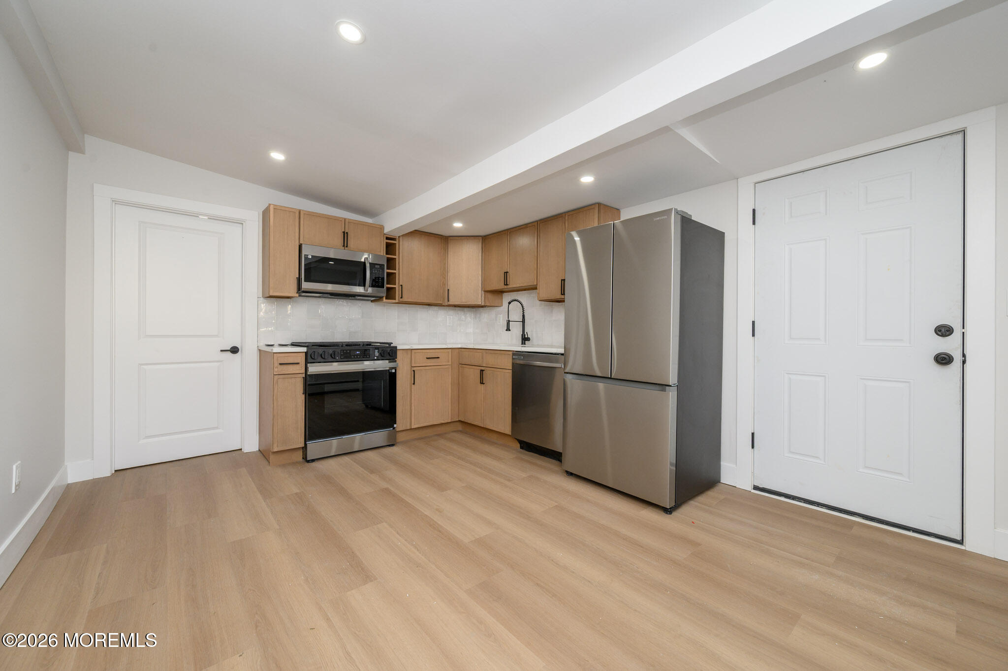 8 Orchard Street Matawan, NJ 07747 - Photo 16 of 34 a kitchen with stainless steel appliances a refrigerator and a stove top oven