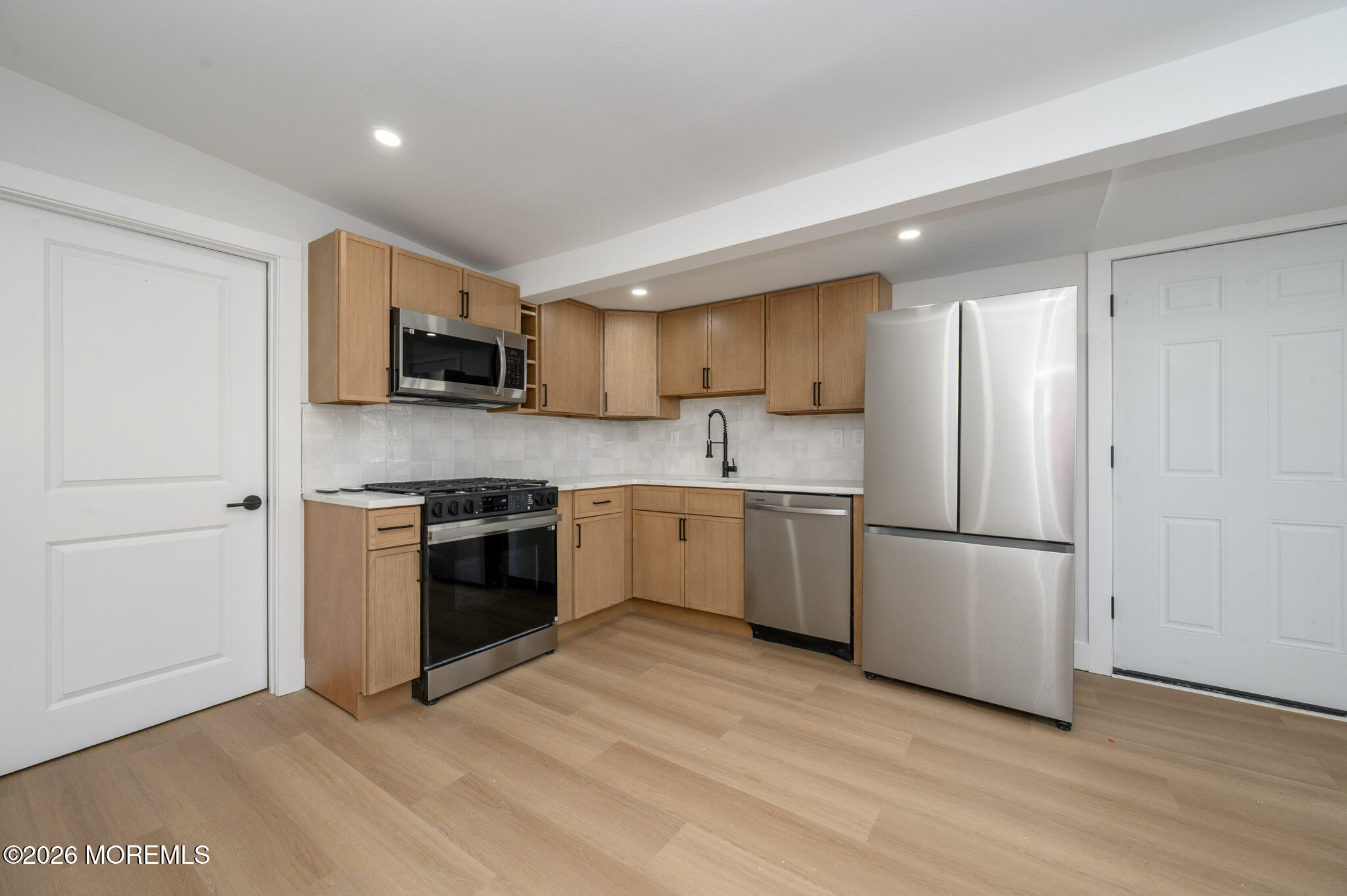 8 Orchard Street Matawan, NJ 07747 - Photo 19 of 34 a kitchen with a sink a refrigerator a microwave and cabinets