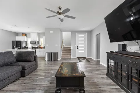 a living room with furniture and a flat screen tv