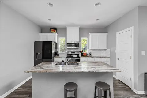 a kitchen with cabinets a sink and appliances