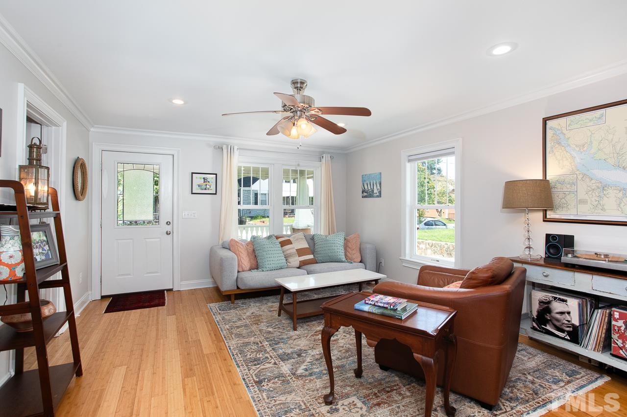 a living room with furniture a fireplace and a window