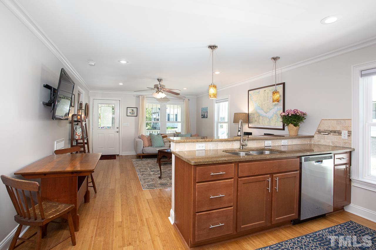1509 South Roxboro Street Durham, NC 27707 - Photo 13 of 30 a kitchen with a sink and wooden cabinets
