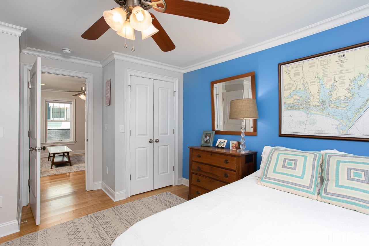 1509 South Roxboro Street Durham, NC 27707 - Photo 17 of 30 a bedroom with a bed and a chandelier