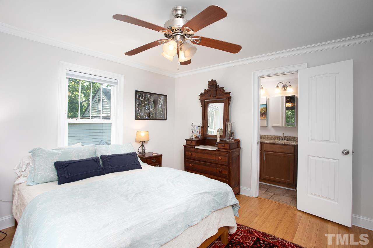 1509 South Roxboro Street Durham, NC 27707 - Photo 20 of 30 a bedroom with a bed and a chandelier