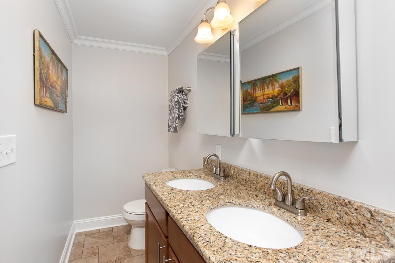1509 South Roxboro Street Durham, NC 27707 - Photo 21 of 30 a bathroom with a granite countertop sink a mirror and a toilet