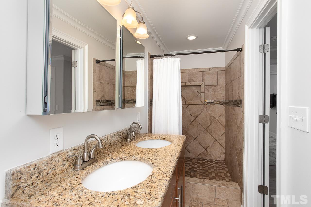 1509 South Roxboro Street Durham, NC 27707 - Photo 22 of 30 a bathroom with a granite countertop sink a mirror and shower