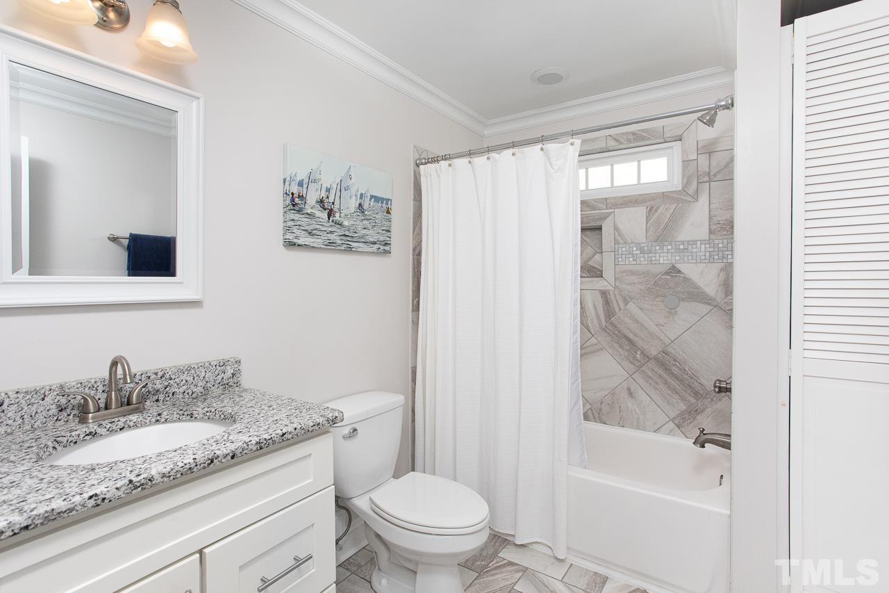 1509 South Roxboro Street Durham, NC 27707 - Photo 23 of 30 a bathroom with a granite countertop sink a toilet and a bathtub