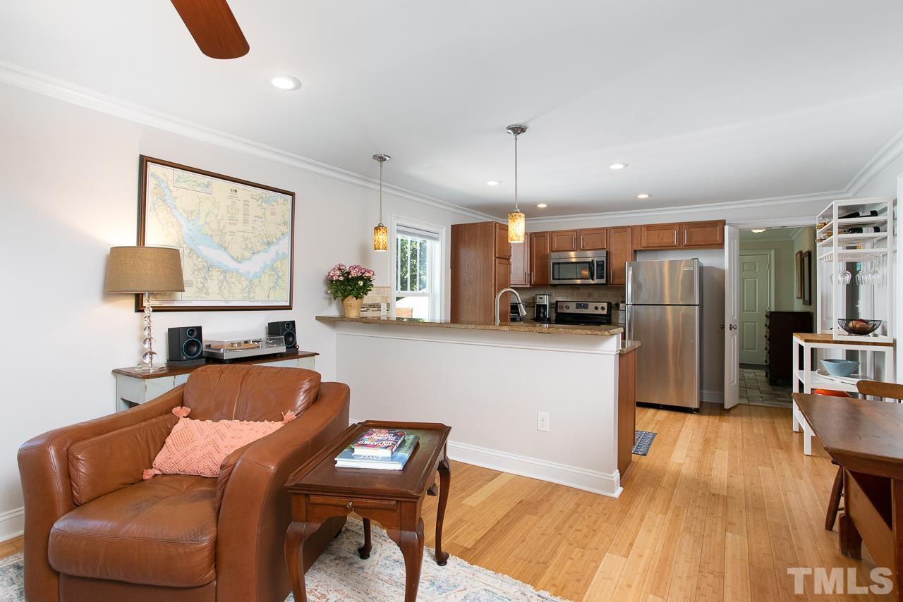 1509 South Roxboro Street Durham, NC 27707 - Photo 7 of 30 a living room with furniture a ceiling fan and a kitchen view