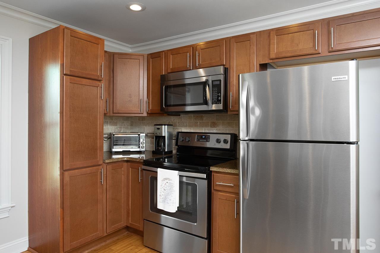 1509 South Roxboro Street Durham, NC 27707 - Photo 10 of 30 a kitchen with stainless steel appliances a refrigerator a microwave a sink and cabinets