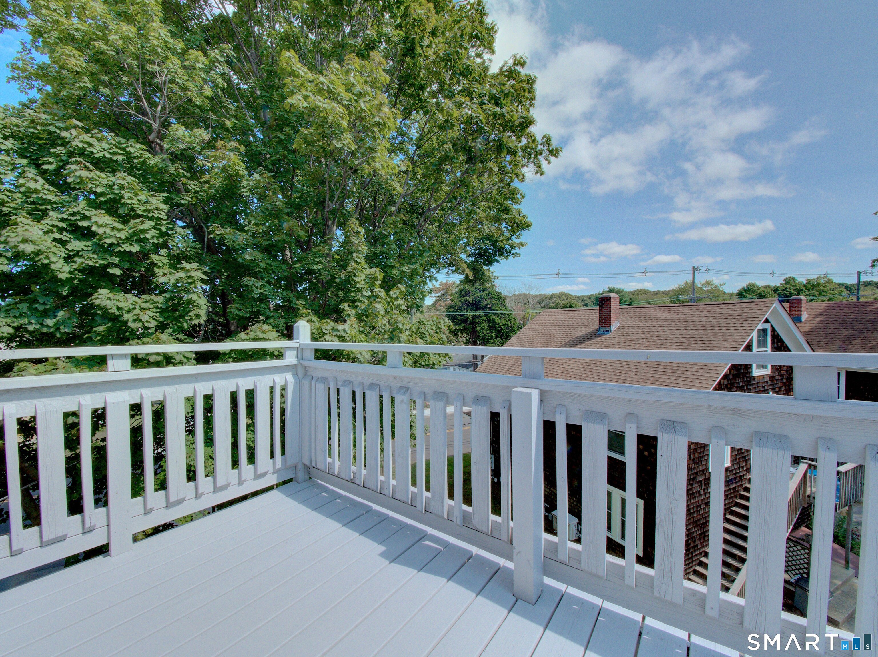 16 Benham Road, Unit D Groton, CT 06340 - Photo 3 of 15 a view of a wooden fence and trees