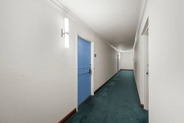 a kitchen with stainless steel appliances granite countertop white cabinets and a refrigerator