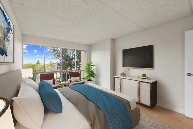 a bedroom with a bed and a flat screen tv