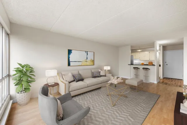 a view of a room with wooden floor and a window