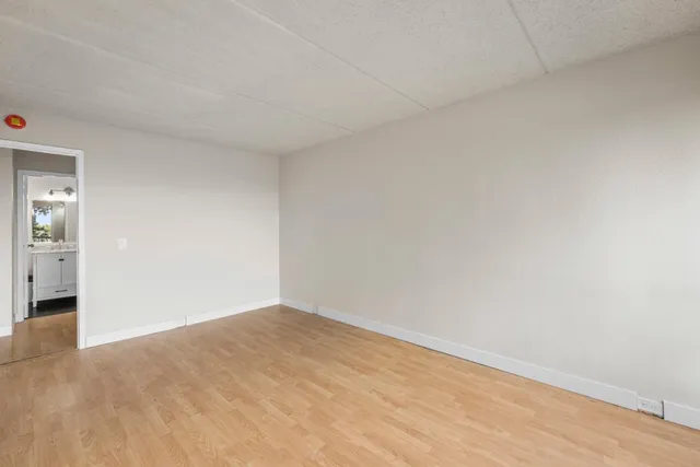 a bathroom with a granite countertop sink toilet a mirror a shower and vanity