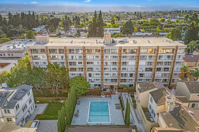 an aerial view of residential houses with city view