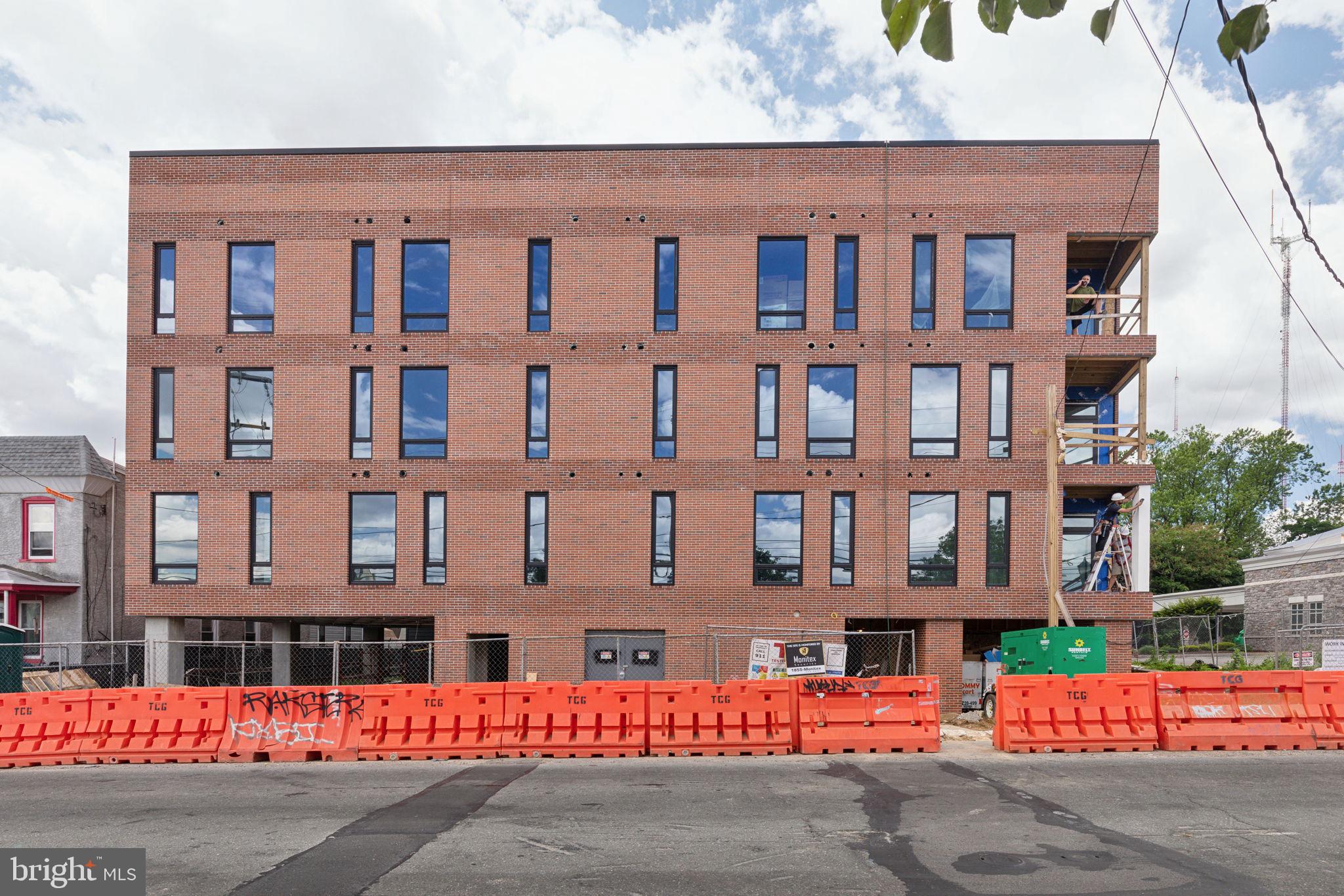 6910 Ridge Avenue, Unit 220 Philadelphia, PA 19128 - Photo 24 of 25 front view of a building with a street