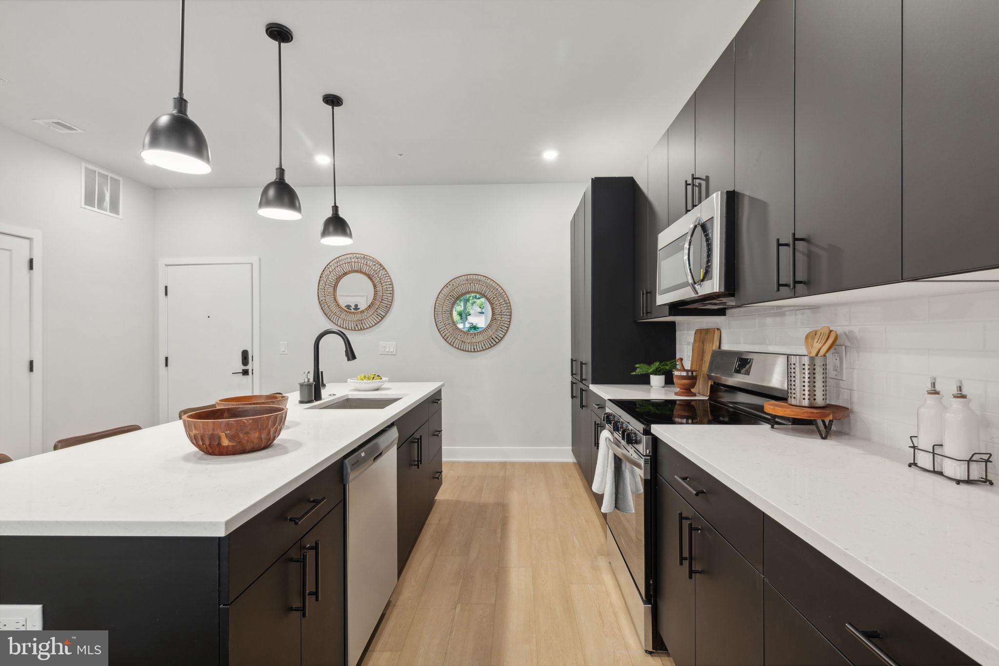 6910 Ridge Avenue, Unit 220 Philadelphia, PA 19128 - Photo 8 of 25 a kitchen with a sink and cabinets