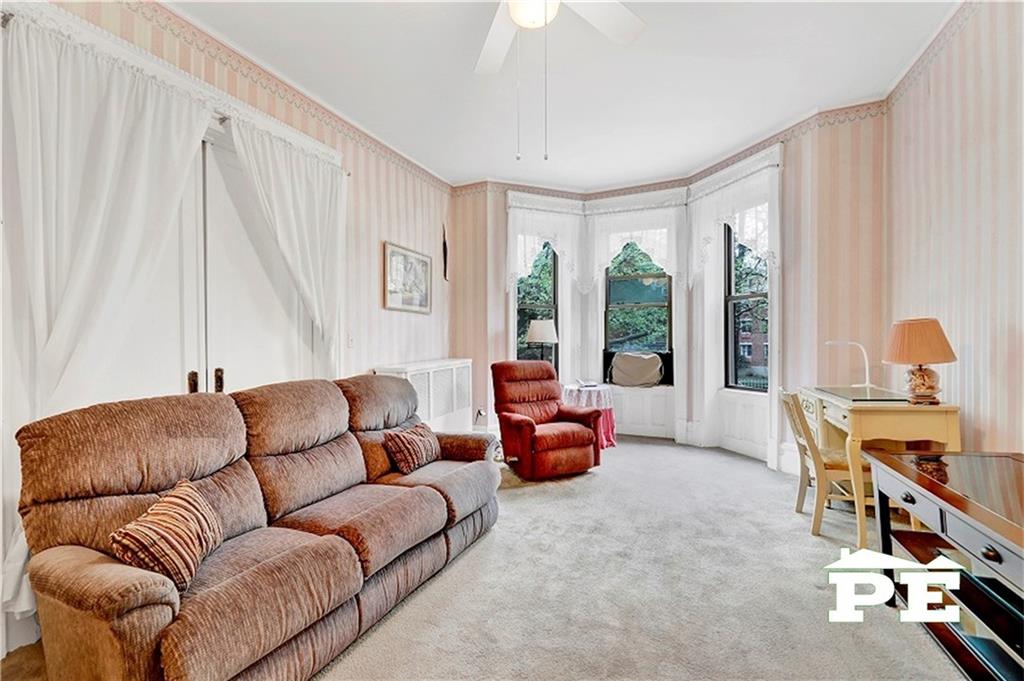 286 Windsor Place Brooklyn, NY 11218 - Photo 16 of 50 a living room with furniture and a large window