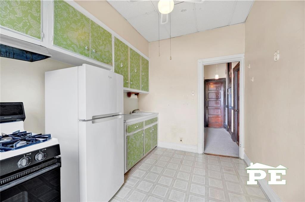 286 Windsor Place Brooklyn, NY 11218 - Photo 41 of 50 a kitchen with a refrigerator and a stove