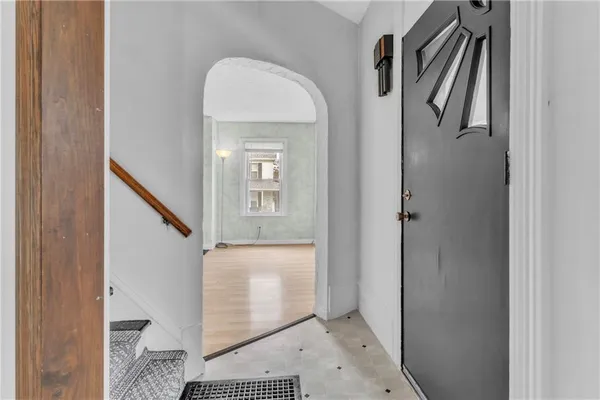 a view of an entryway with wooden floor