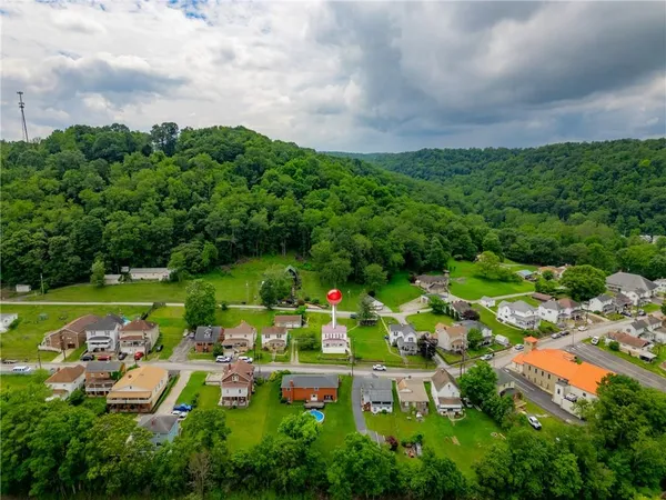 an aerial view of a houses with garden