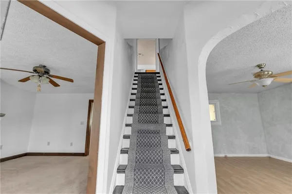 a view of staircase with wooden floor