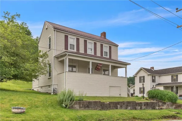 a front view of a house with a yard