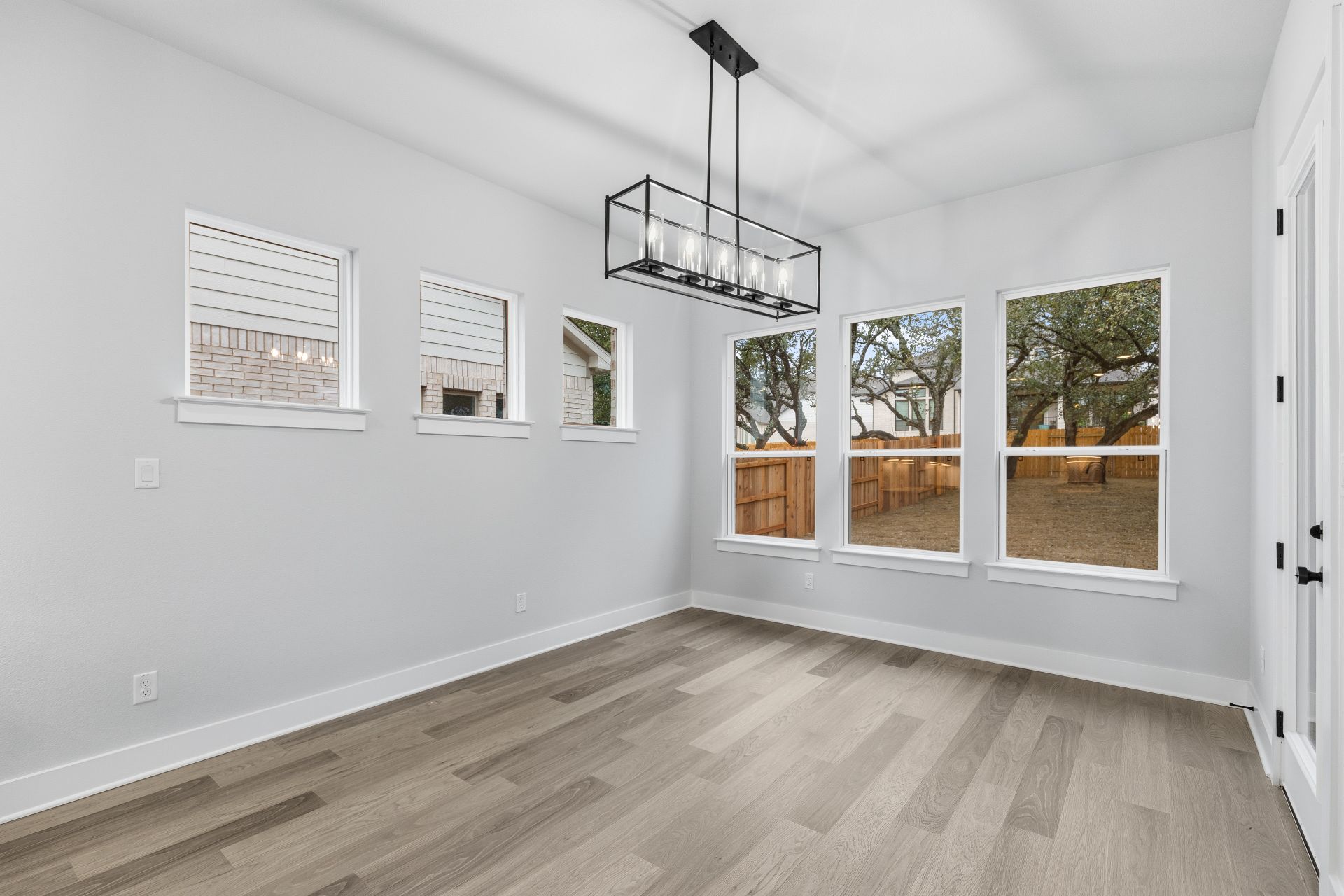 1713 Snowdrop Drive Georgetown, TX 78628 - Photo 12 of 35 a view of empty room with wooden floor and fan
