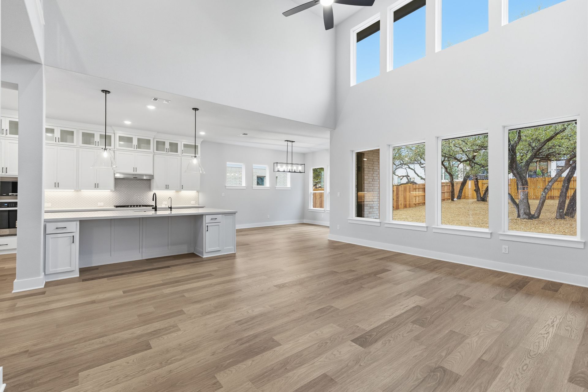 1713 Snowdrop Drive Georgetown, TX 78628 - Photo 16 of 35 a view of kitchen with kitchen island a sink wooden floor and a view of living room