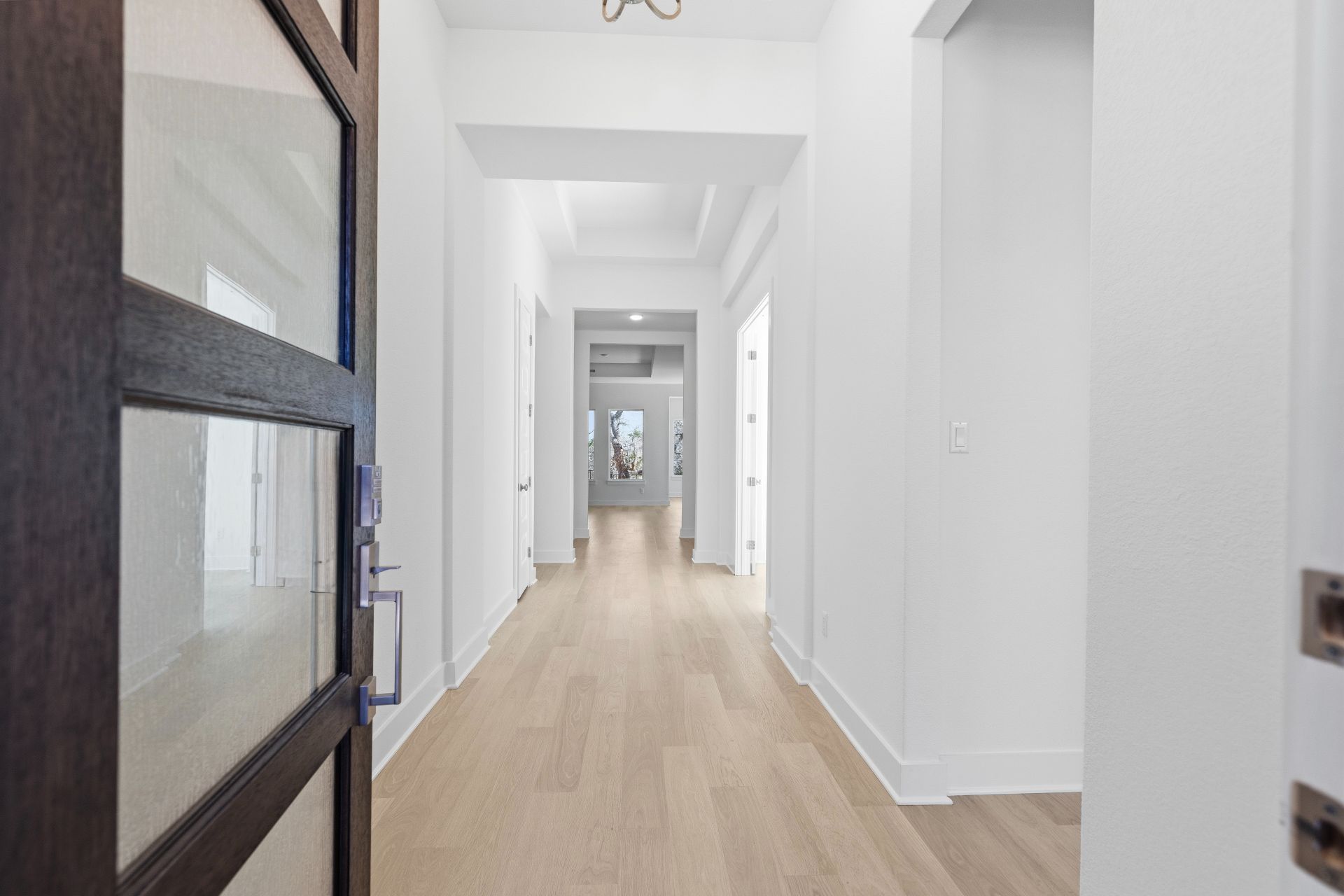 1713 Snowdrop Drive Georgetown, TX 78628 - Photo 6 of 35 a view of a hallway with a wooden floor