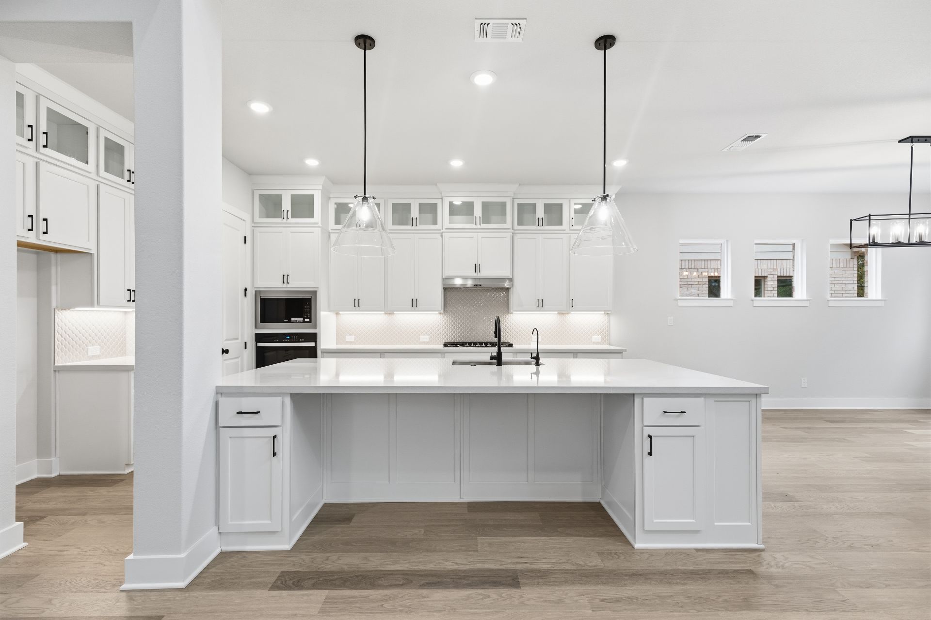1713 Snowdrop Drive Georgetown, TX 78628 - Photo 7 of 35 a large kitchen with stainless steel appliances kitchen island a large counter space a sink refrigerator and cabinets