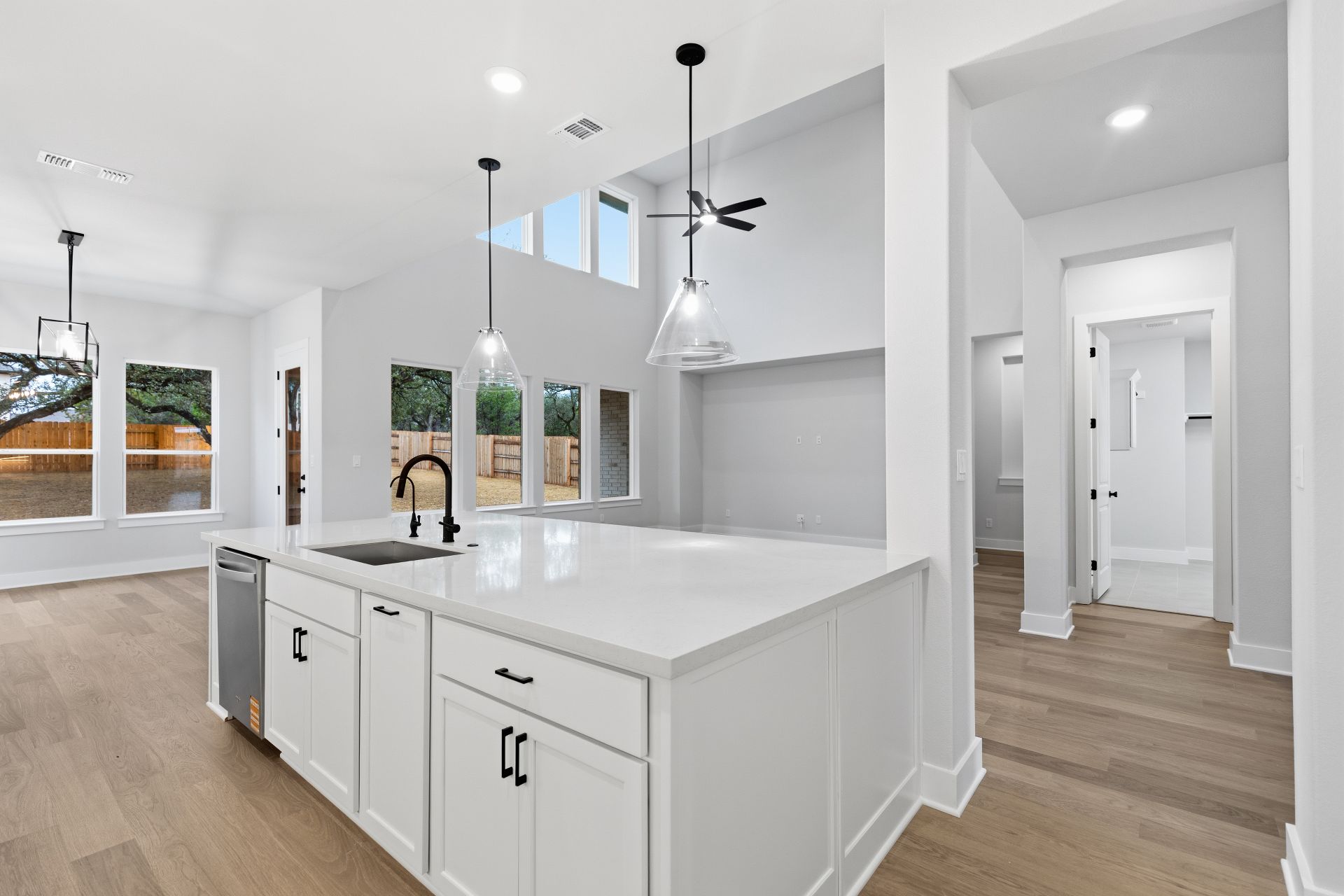1713 Snowdrop Drive Georgetown, TX 78628 - Photo 10 of 35 a kitchen with a sink dishwasher and white cabinets with wooden floor