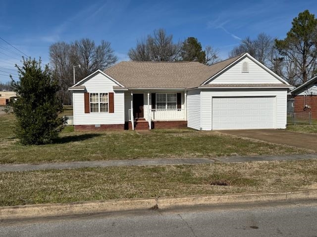 840 Butler Street Bolivar, TN 38008 - Photo 1 of 16 Single story home with concrete driveway, a front lawn, a porch, an attached garage, and a shingled roof