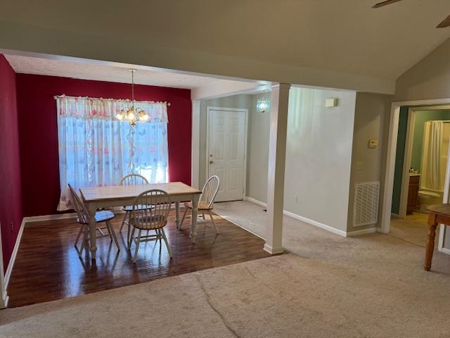 840 Butler Street Bolivar, TN 38008 - Photo 4 of 16 Dining space featuring carpet flooring, lofted ceiling, a ceiling fan, suspended lighting, and wood finished floors