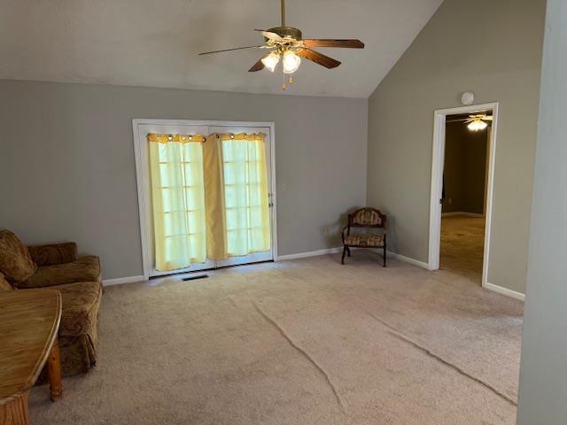 840 Butler Street Bolivar, TN 38008 - Photo 5 of 16 Living room featuring ceiling fan, vaulted ceiling, and carpet floors