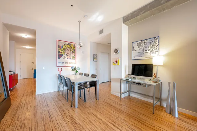 a kitchen with stainless steel appliances granite countertop a sink a stove and refrigerator