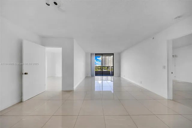 a view of livingroom with kitchen and entryway