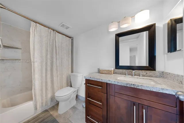 an empty room with sliding glass door and shower