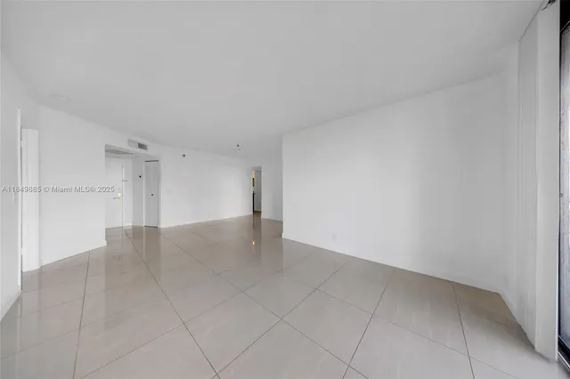 a view of a room with a floor to ceiling window and a ceiling fan