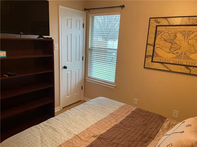 a bedroom with a bed and a window