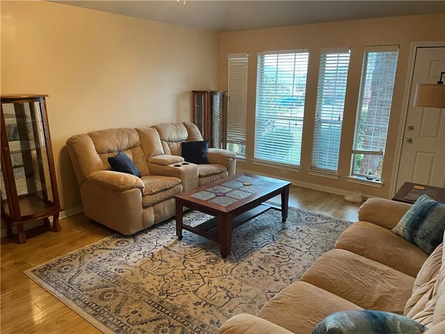 a living room with furniture and a rug
