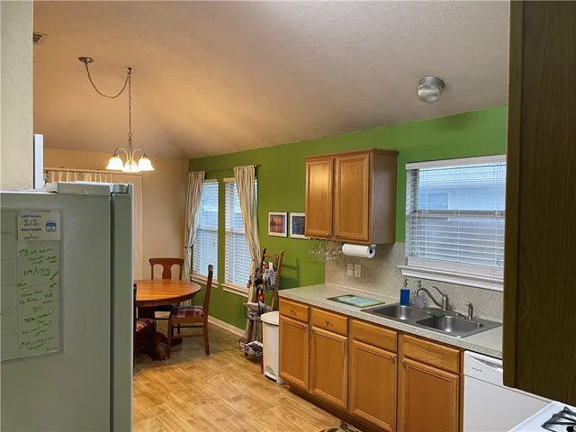 a kitchen with granite countertop a sink and a stove