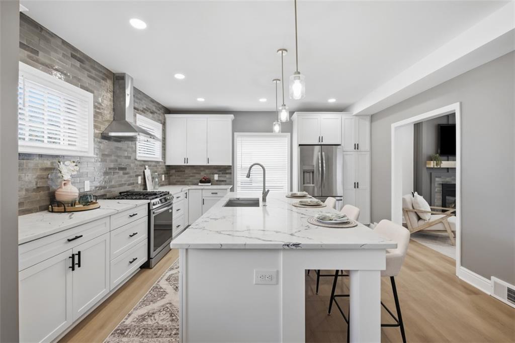 338 4th Street Beaver, PA 15009 - Photo 15 of 50 a kitchen with kitchen island granite countertop a sink and white cabinets