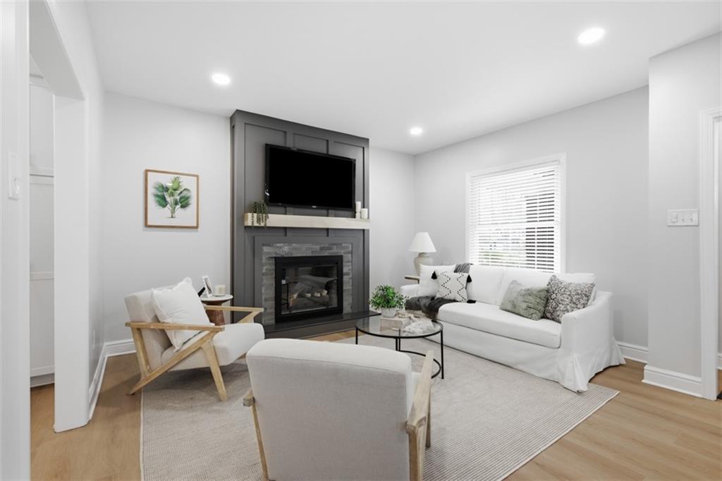 338 4th Street Beaver, PA 15009 - Photo 9 of 50 a living room with furniture a flat screen tv and a fireplace