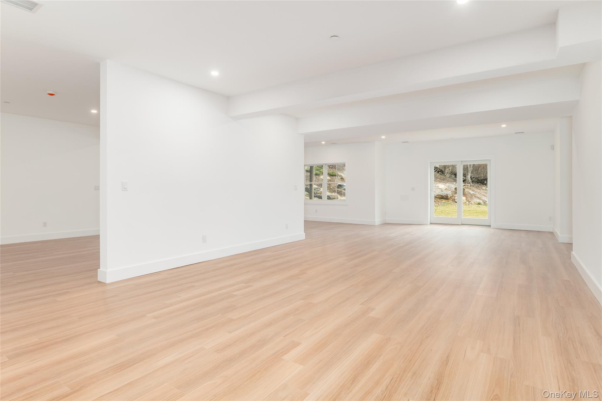 63 Buckout Road West Harrison, NY 10604 - Photo 27 of 34 a view of an empty room with a window and wooden floor