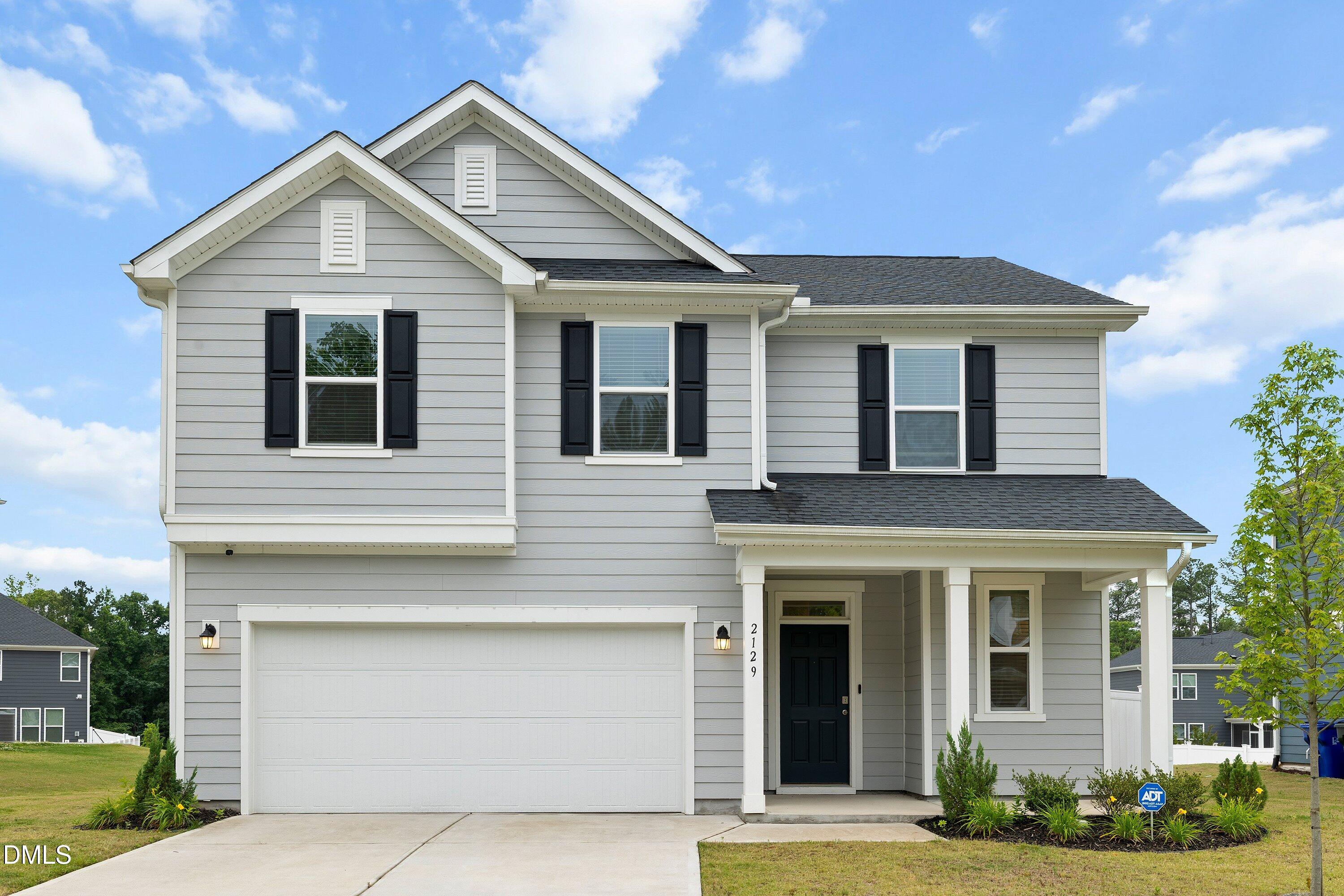 2129 Crestwood Rdg Drive Durham, NC 27704 - Photo 1 of 15 a front view of a house with garden