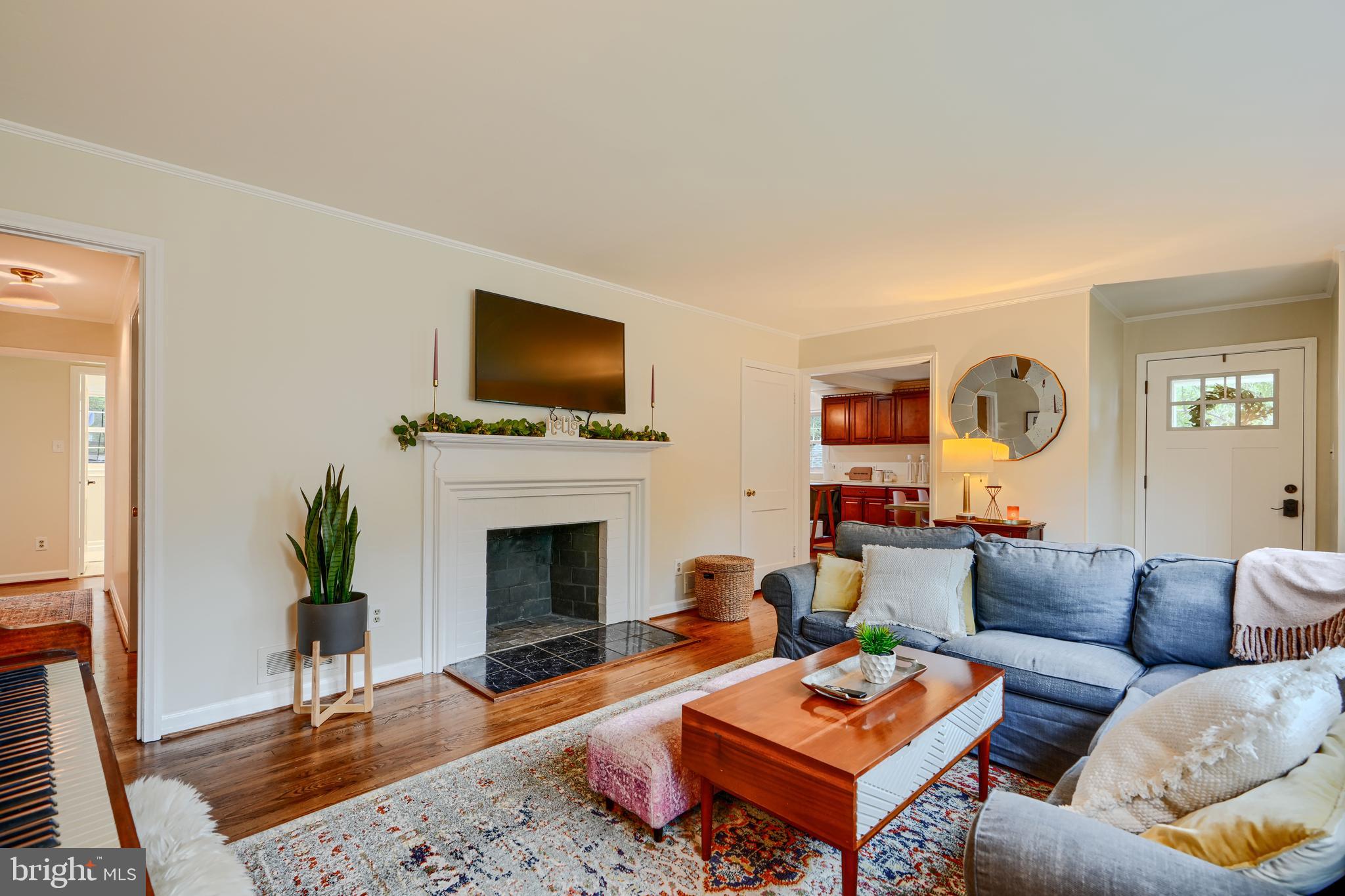 8808 Wolverton Road Baltimore, MD 21234 - Photo 13 of 57 a living room with furniture a fireplace and a flat screen tv