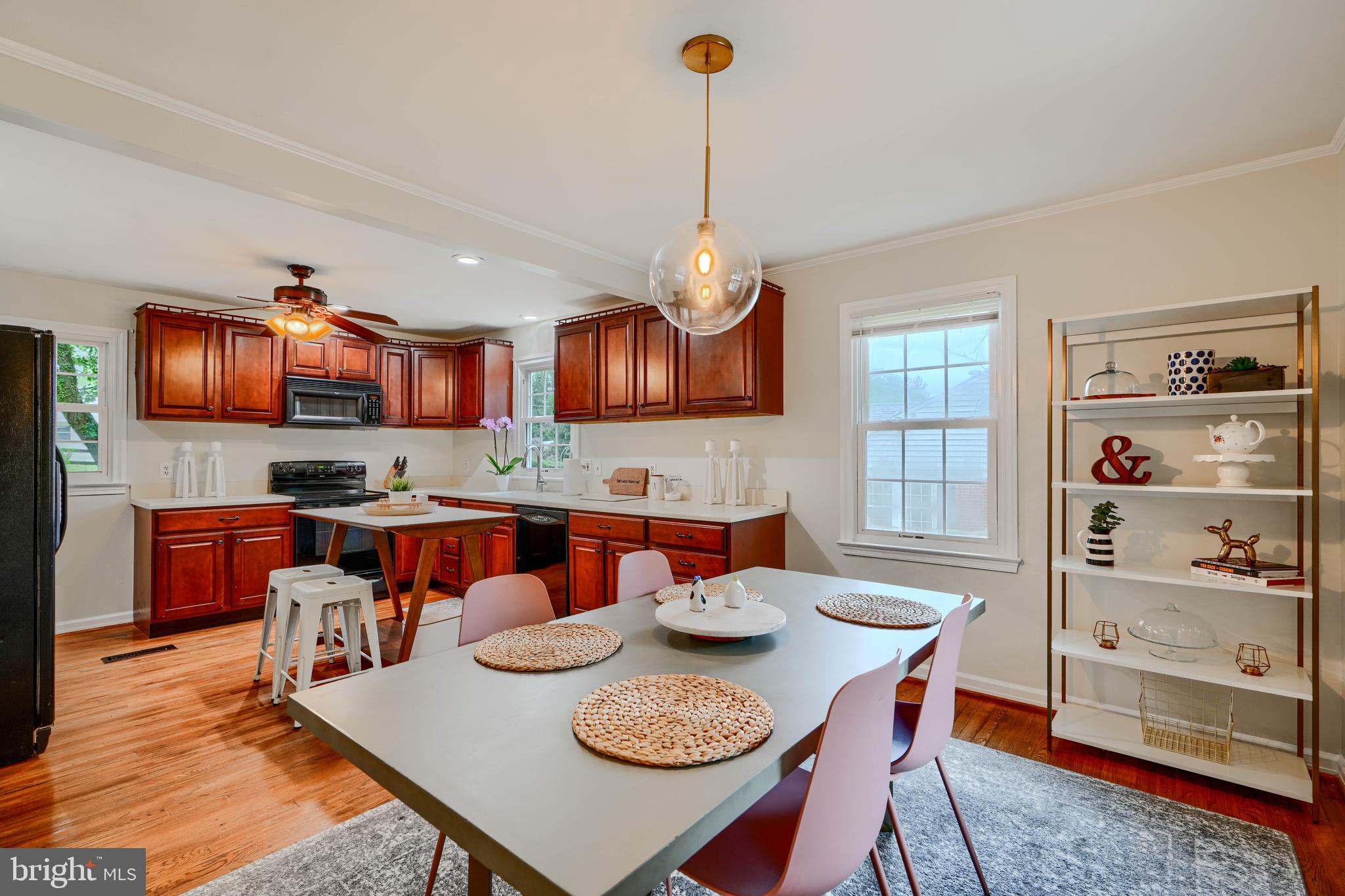 8808 Wolverton Road Baltimore, MD 21234 - Photo 15 of 57 a view of a dining room with furniture a kitchen and chandelier