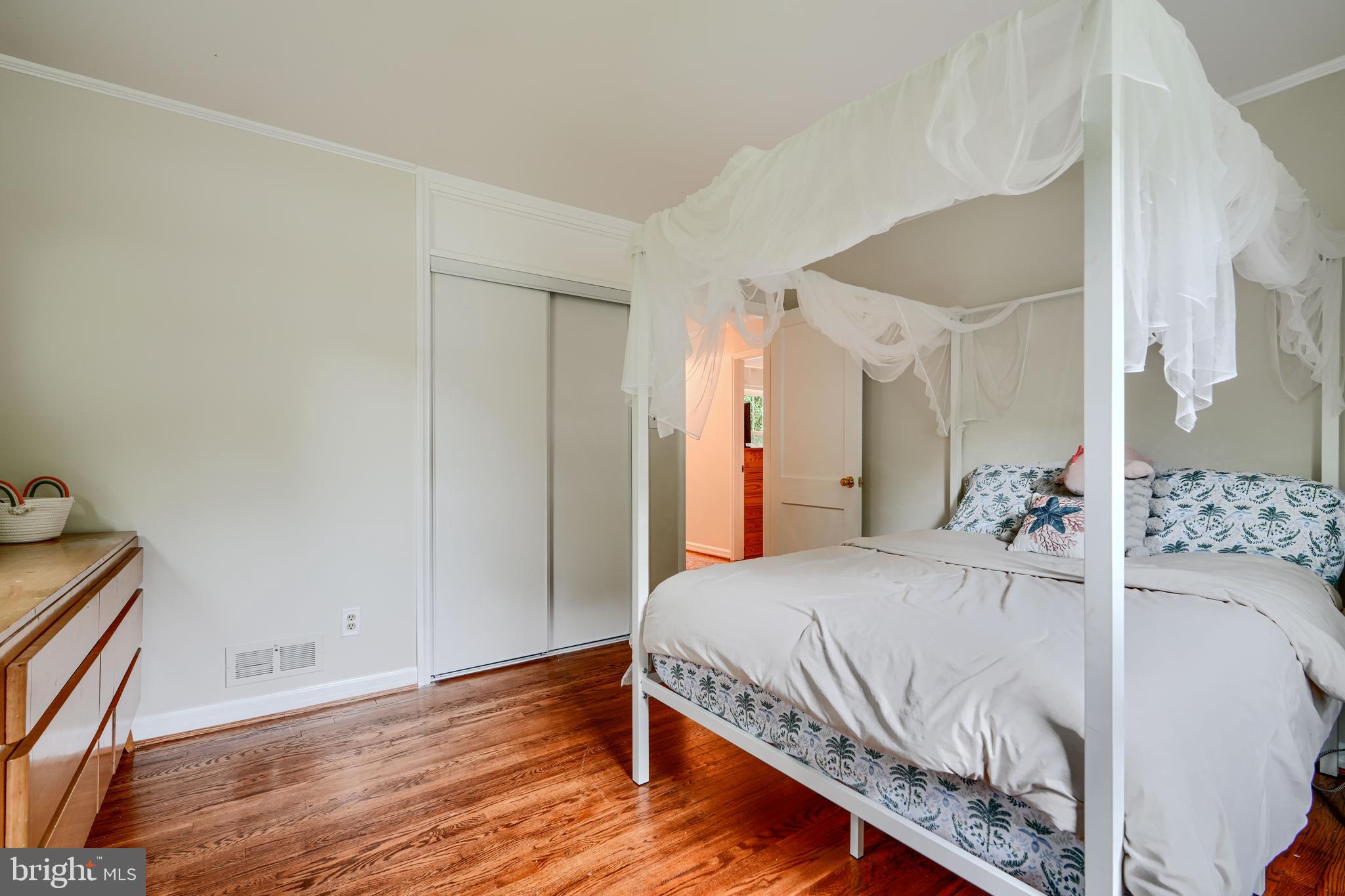 8808 Wolverton Road Baltimore, MD 21234 - Photo 26 of 57 a bedroom with a bed and a large mirror on the dresser